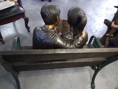 BOY AND GIRL WITH A BOOK ON A BENCH
