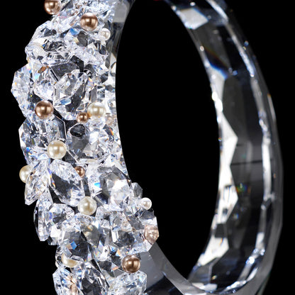 A RING OF CRYSTAL ENHANCED WITH SWAROVSKI PEARLS