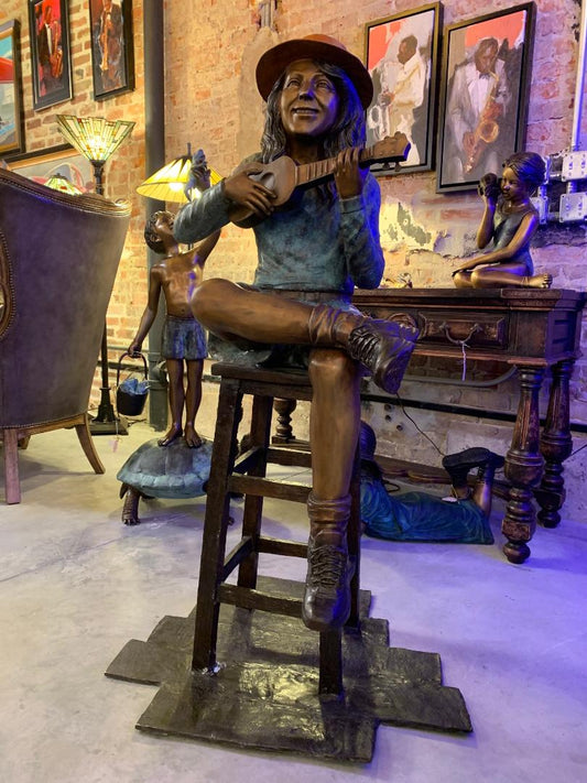 GIRL PLAYING UKULELE ON A STOOL