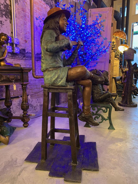 GIRL PLAYING UKULELE ON A STOOL